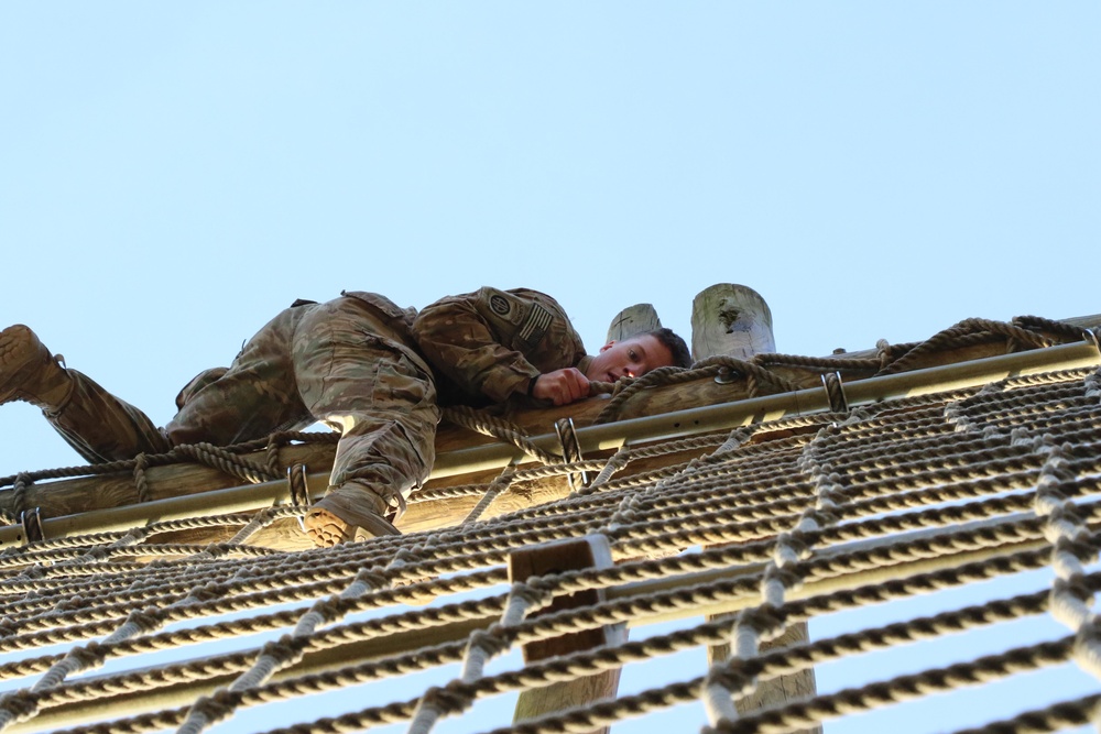 Paratrooper climbs obstacle to stay ready