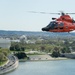 Coast Guard helicopter crew flies above the cherry blossoms