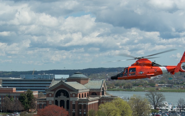 Coast Guard helicopter crew flies above the cherry blossoms