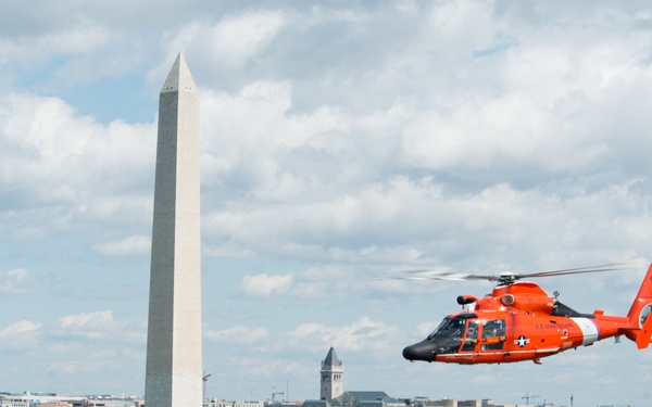 Coast Guard helicopter crew flies above the cherry blossoms