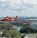 Coast Guard helicopter crew flies above the cherry blossoms