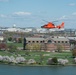 Coast Guard helicopter crew flies above the cherry blossoms