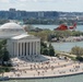 Coast Guard helicopter crew flies above the cherry blossoms