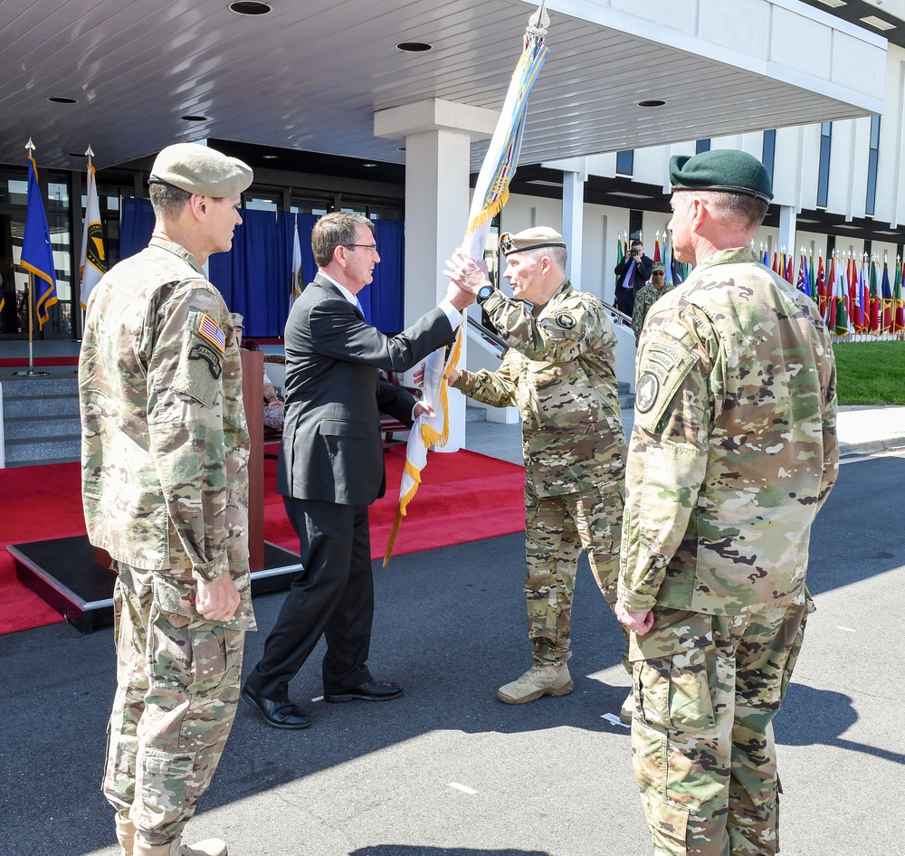 SD passes a guidon to Gen. Raymond Thomas during a change-of-command ceremony