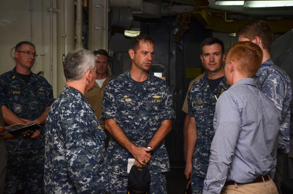 Capt. St. John, CO, USS Frank Cable, gives a Congressional delegation tour in Guam