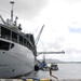 USS Frank Cable conducts maintenance on USS Topeka in port Polaris Point, Guam.