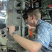 Will Rogers, a military legislative assistant, looks through the periscope of USS Topeka during a Congressional delegation tour