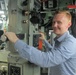 Alec Johnson, a military legislative assistant, looks through the periscope of USS Topeka during a Congressional delegation tour