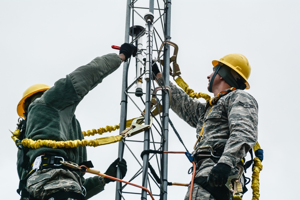 Airmen repair communication towers