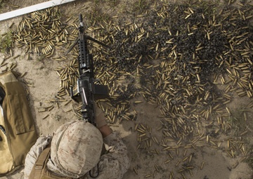 Military police shoot machine guns in preparation for SPMAGTF