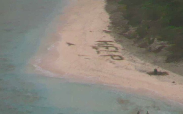 castaways rescued after spelling 'help' with palm leaves on remote island