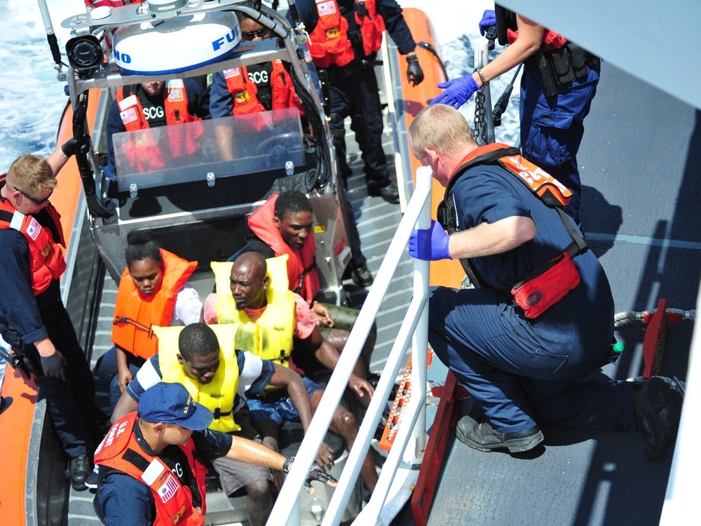 The U.S. Coast Guard Cutter Bernard Webber crew embarks people rescued from a sinking vessel southwest of Freeport, Bahamas on April 9, 2016.