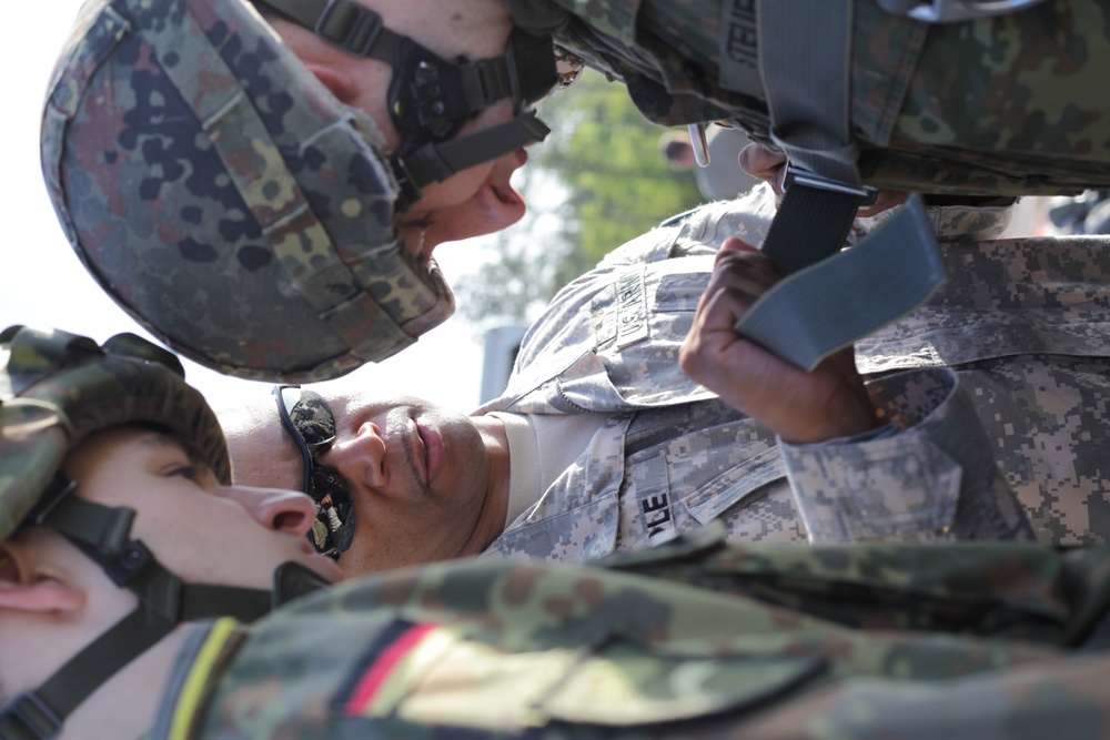 U.S. Army Sgt. First Class assists German paratroopers