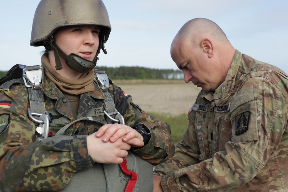 U.S. Army Capt. assists German Capt. on donning the MC-6 Harness