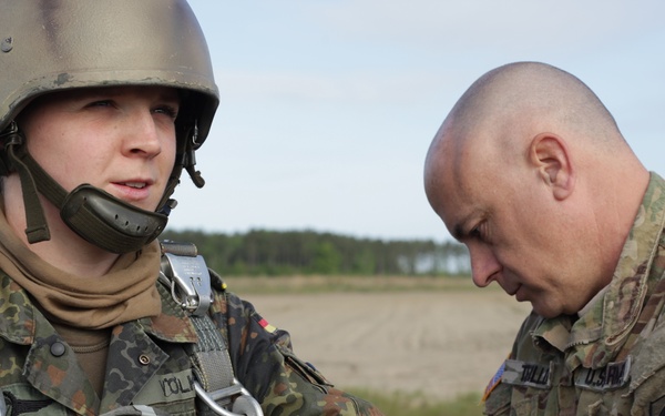 U.S. Army Capt. assists German Capt. on donning the MC-6 Harness