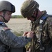 U.S. Army soldier assists a Cpl. from the Royal Army