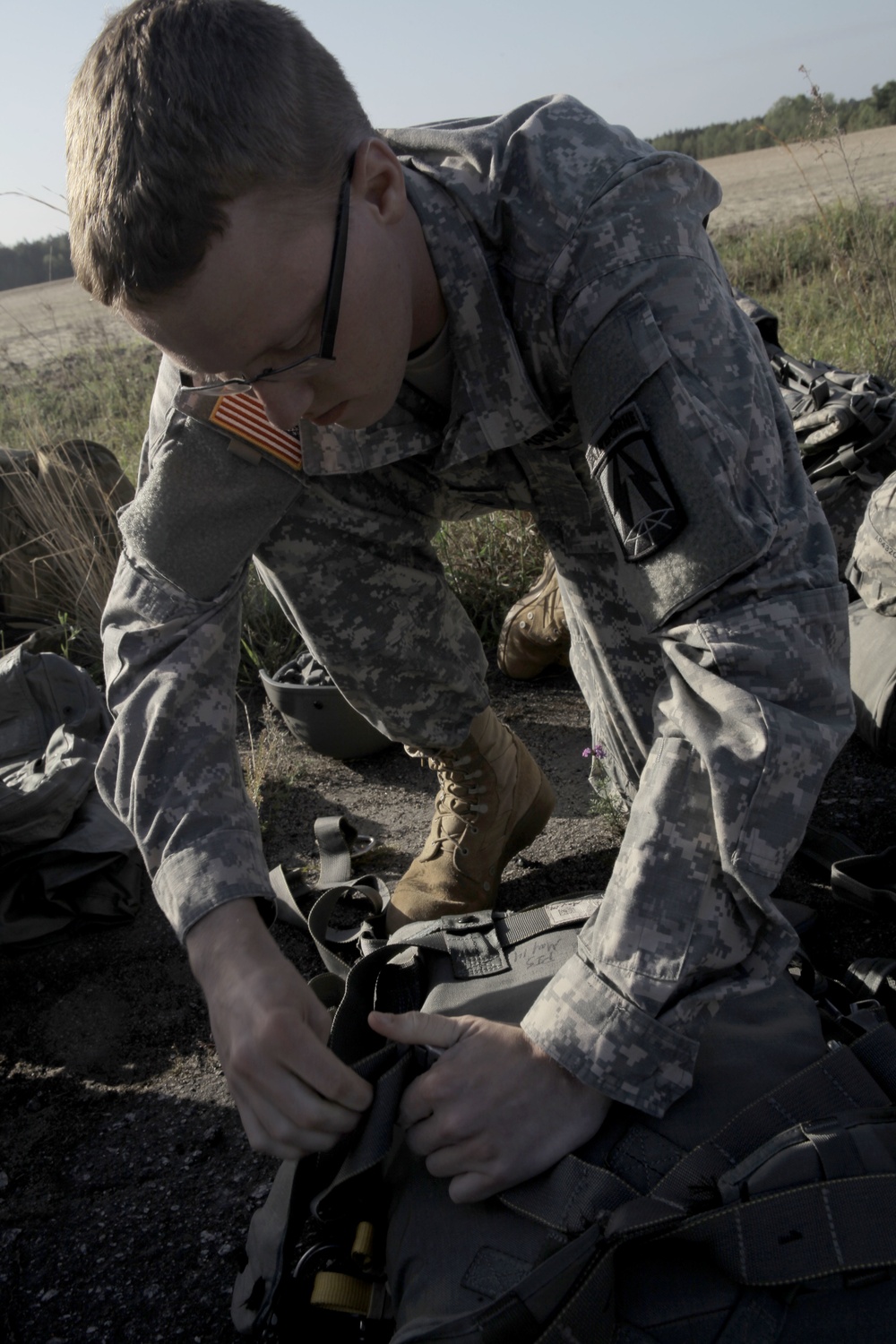 U.S. Army Soldier adjusts epuipment.