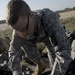 U.S. Army Soldier adjusts epuipment.