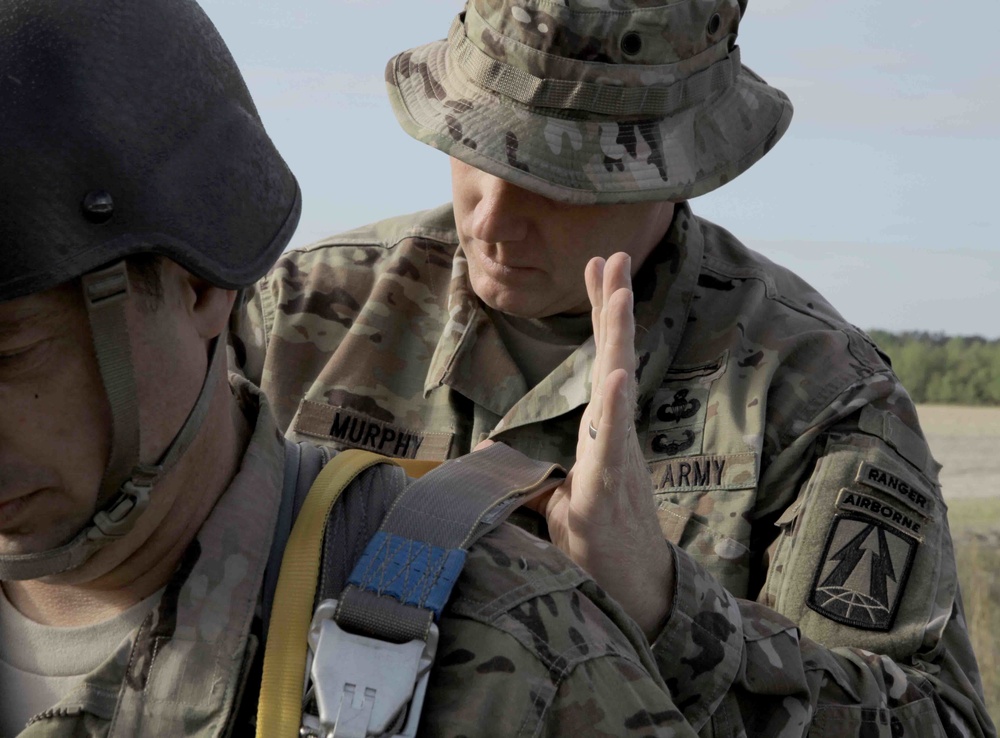 U.S. Army jumpmaster checks parachute.