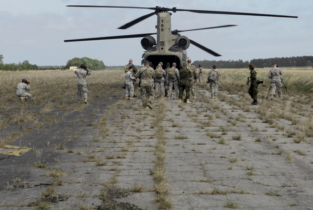 Combat camera of different nationalities document airborne operations.