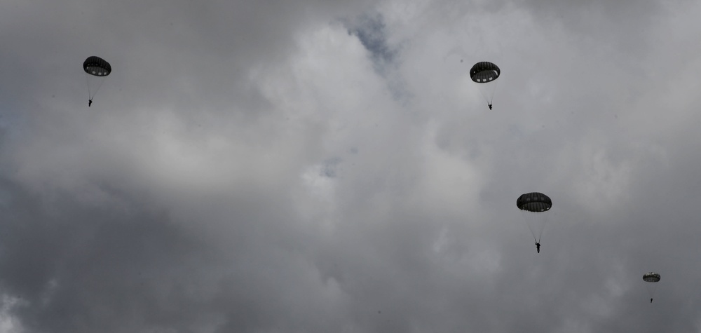 Paratroopers descend onto an airfield
