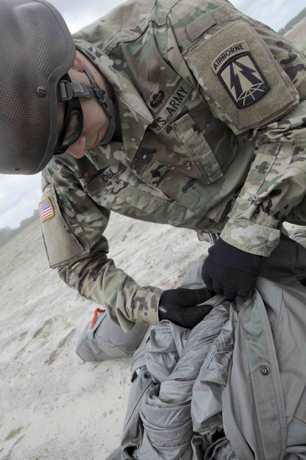 U.S. Army soldier packs parachute.