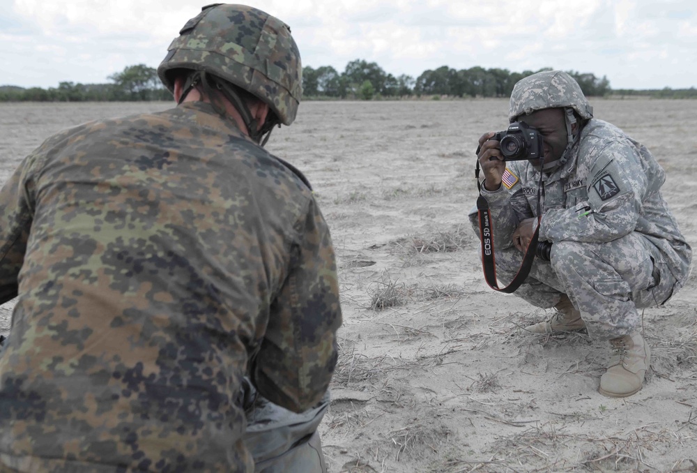 Combat Camera soldier documents dropzone operations.