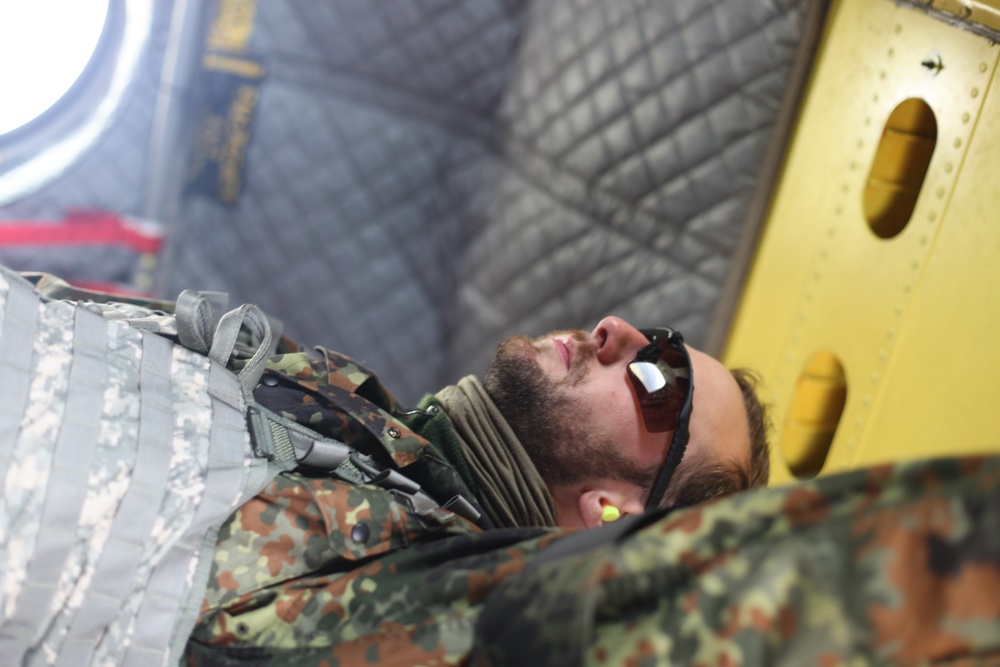 German jumpmaster observes the paratroopers as the leave CH-47 Chinook.