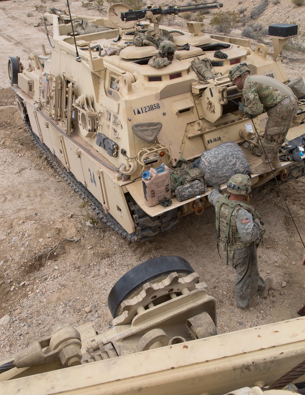 Soldiers assigned to the 1st Battalion, 67th Armored Regiment, 3rd Brigade Combat Team, 1st Armored Division, stock maintenance supplies on a M88A2 Hercules recovery vehicle during Decisive Action Training Exercise 16-05 at the National Training Center in Fort Irwin, Calif