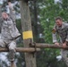 Best Ranger competitors climb an obstacle