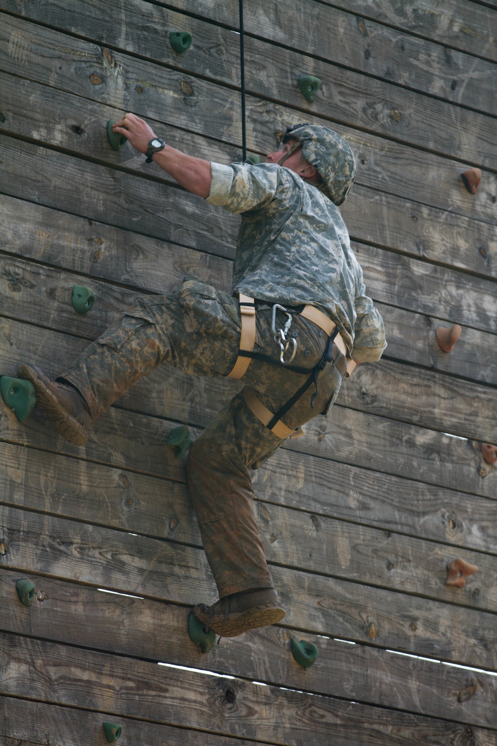 Army Ranger climbs a wall during competition