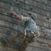 Army Ranger climbs a wall during competition