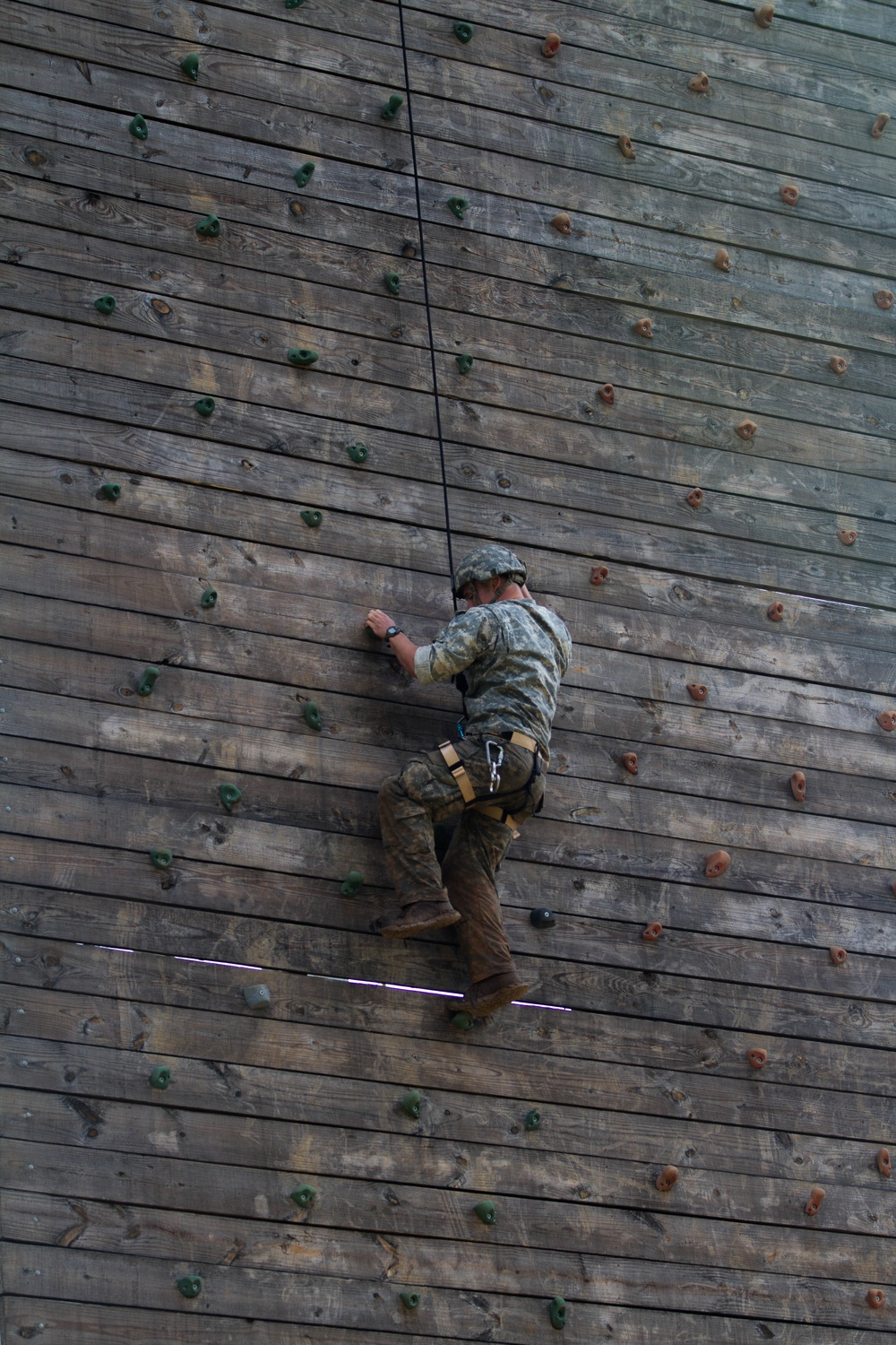 Army Ranger climbs a wall during competition