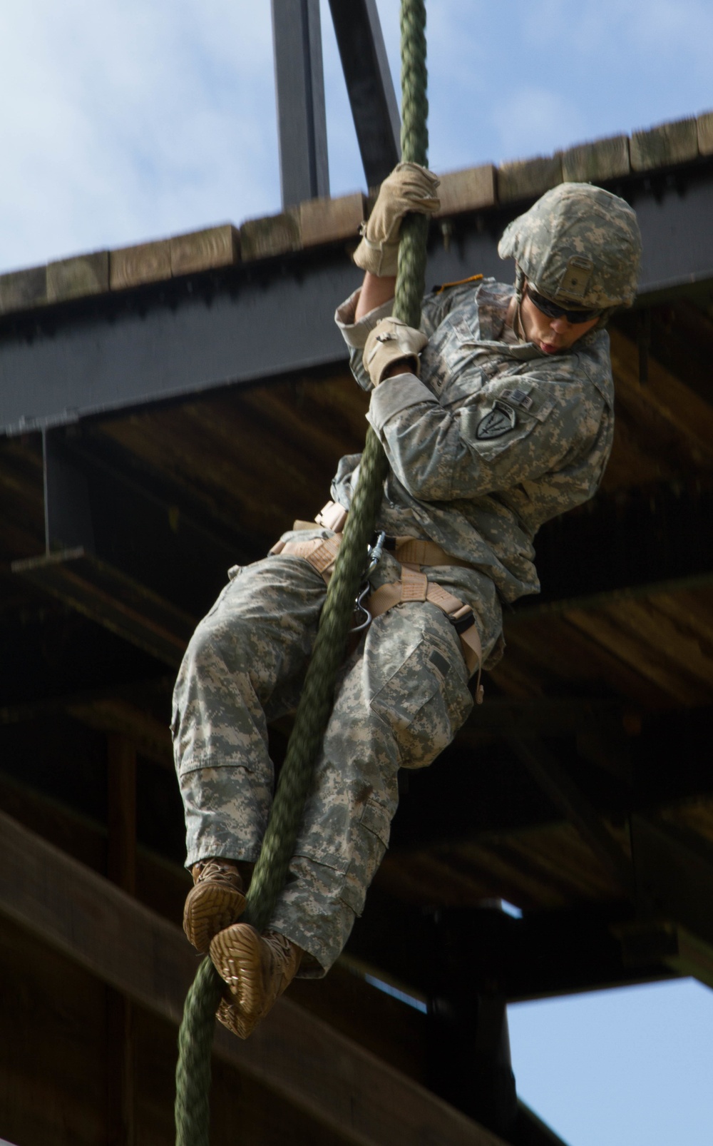 Army Ranger slides down a rope during competition