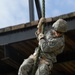 Army Ranger slides down a rope during competition