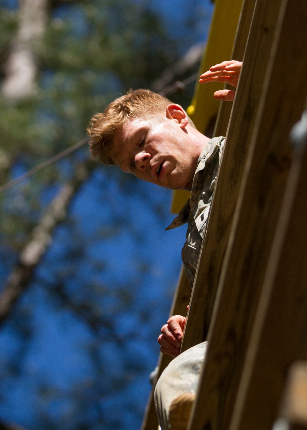 Army Ranger climbs down an obstacle