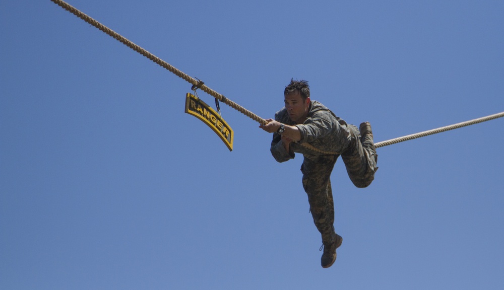 Army Ranger slides across rope