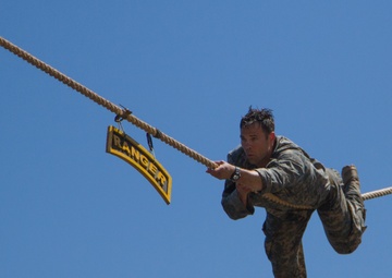 Army Ranger slides across rope