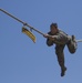 Army Ranger slides across rope