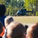Students watch as an OH-58D Kiowa Warrior lands