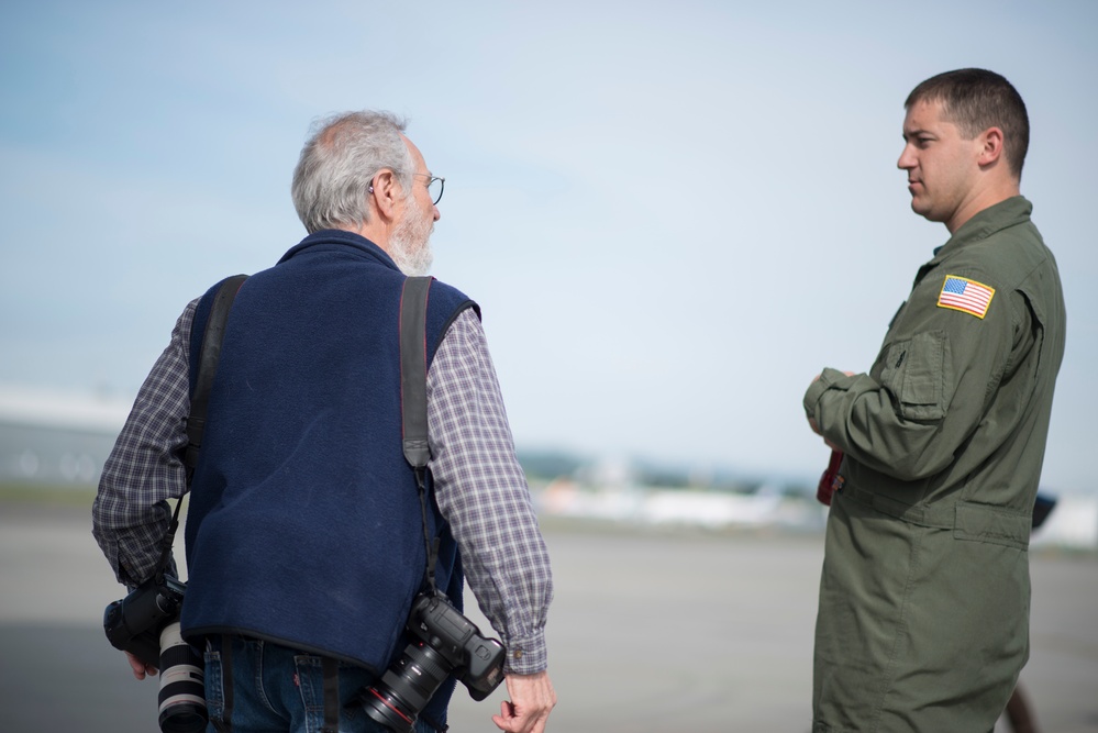 A Coast Guard Air Station Sacramento crewmember speaks to a Seattle reporter