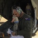 RAAF Airmen work with USAF Airmen to upload Humvee