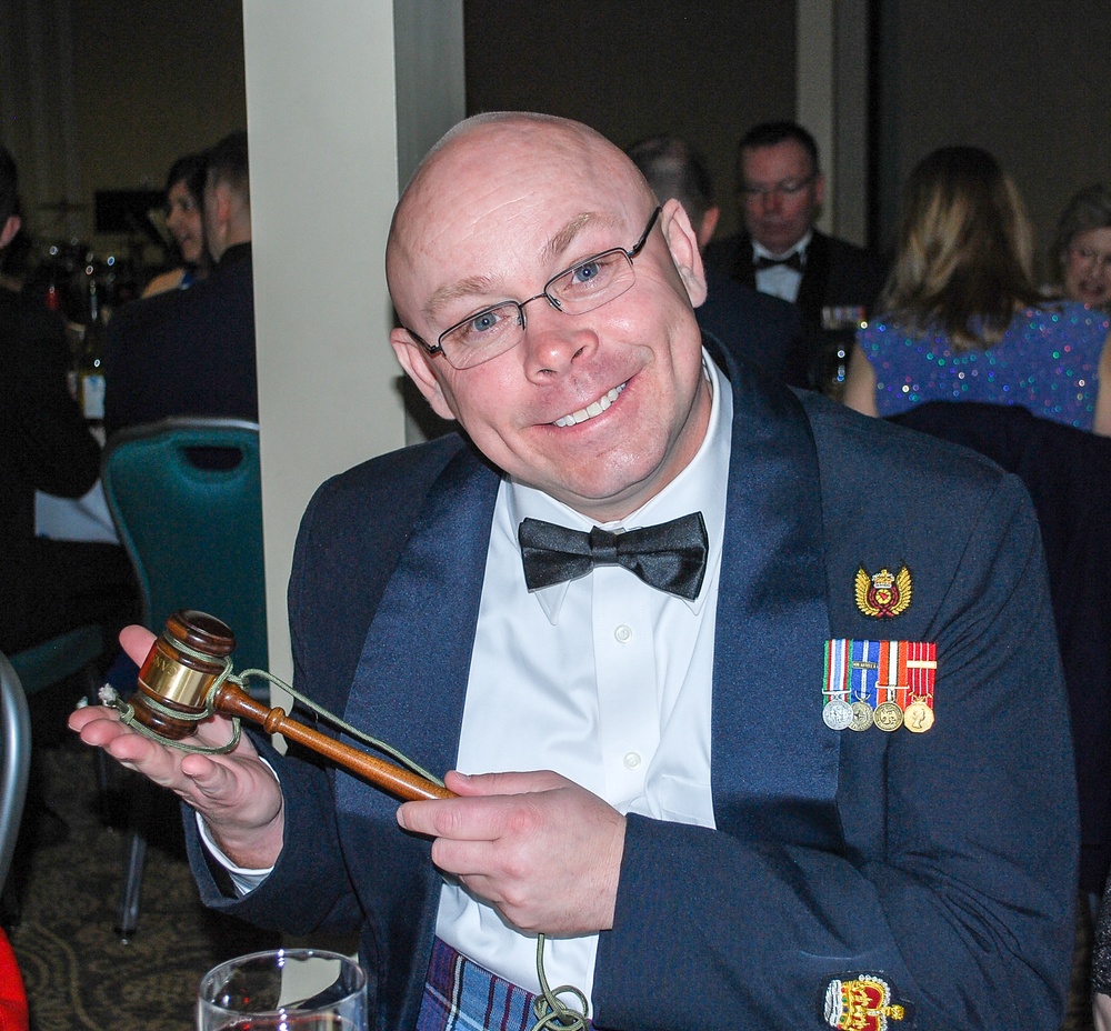 Canadian Warrant Officer Richard Martin shows off his newly acquired official mess gavel
