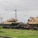 U.S. Marines team up with locally-sourced contractors to offload mechanized equipment