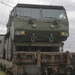 U.S. Marines team up with locally-sourced contractors to offload mechanized equipment