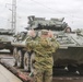U.S. Marines team up with locally-sourced contractors to offload mechanized equipment
