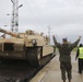 U.S. Marines team up with locally-sourced contractors to offload mechanized equipment