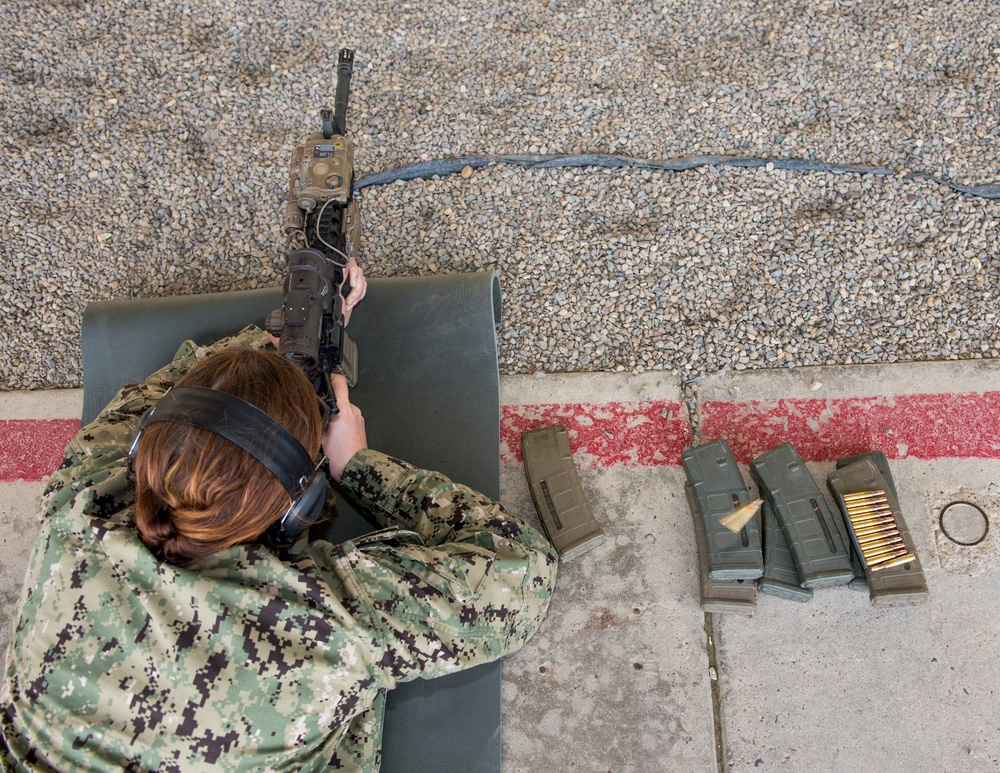 U.S. military combat cameramen train in a small arms qualification course.