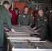 A Coast Guard Air Station crew unbox a rescued sea turtle