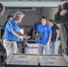 An Air Station Sacramento aircrew and members from Sea World unload 2 rescued sea turtles
